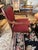 Classic Empire style armchair having walnut frame with gilded dolphins on the arms and cranberry upholstery. Duffy