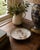 A charming late 20th century porcelain catchall by Mottahedeh, made in Portugal and decorated with a whimsical garden-...