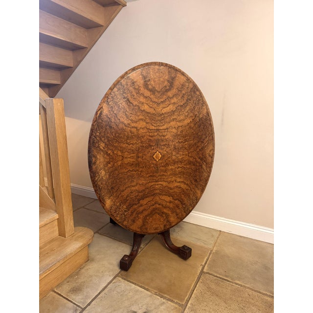 Fine quality antique Victorian well figured quarter veneered burr walnut oval loo table, having a polished burr walnut...
