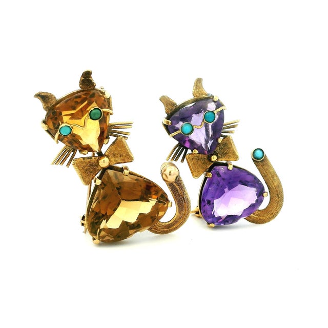 A charming pair of mid-century figural cat brooches crafted in 18 karat yellow gold. Each playful feline is formed from...