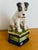 Large pottery trinket box with dog, Jack Russel Terrier sitting on top. Box is painted green and navy blue. I’m not sure...