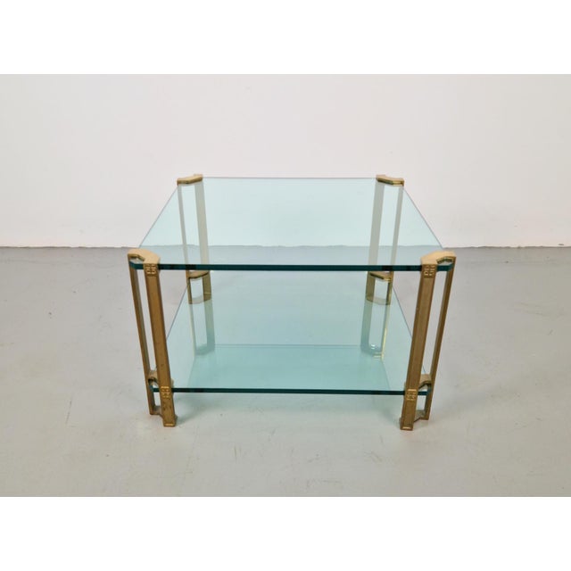 This elegant T24 coffee table/side table, designed by Peter Ghyczy in the 1970s, features the original brass legs made by...