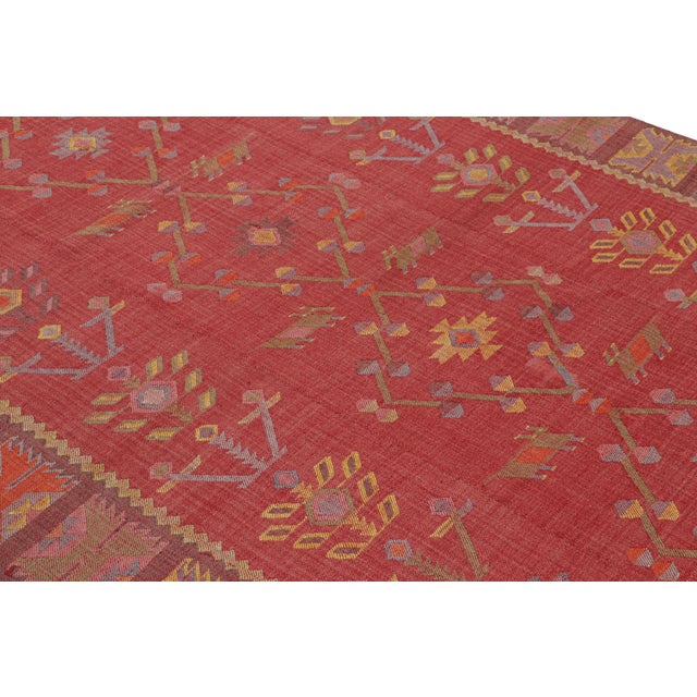 Handwoven in a wool flatweave originating from Turkey circa 1950-1960, this vintage Kilim rug connotes a mid-century Kilim...