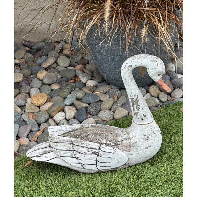 Charming vintage hand-carved wooden swan decoy sculpture with beautiful aged white paint and natural weathering that adds...