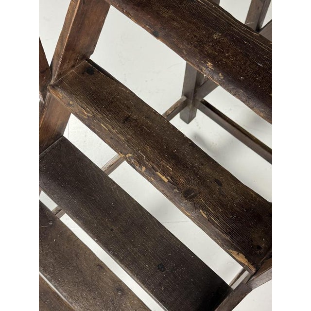 Library ladder on wheels, late 19th / early 20th century. Large wooden rolling library ladder, presumably from a library,...