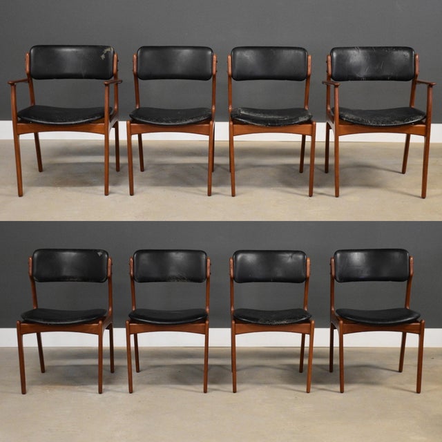 A set of eight mid century modern teak dining chairs designed by Erik Buch. Leather seats and backs. One seat has black...