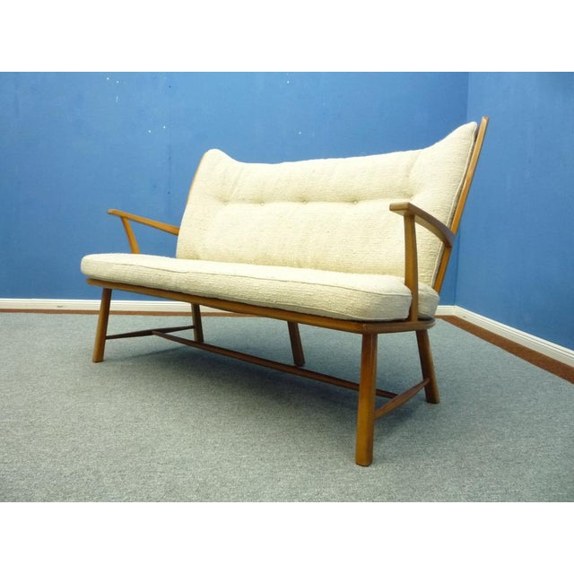 Very rare and filigree bench from the fifties. Elegant design and made of solid cherry wood. Cherry wood frame with minor...