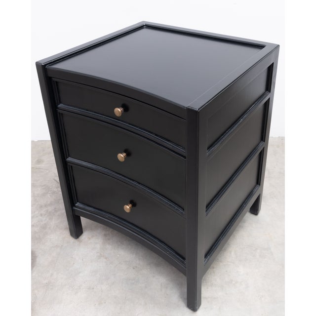 Pair of Noir Furniture three drawer nightstands. Black stained Mahogany with brass hardware. Items do not have any labels...