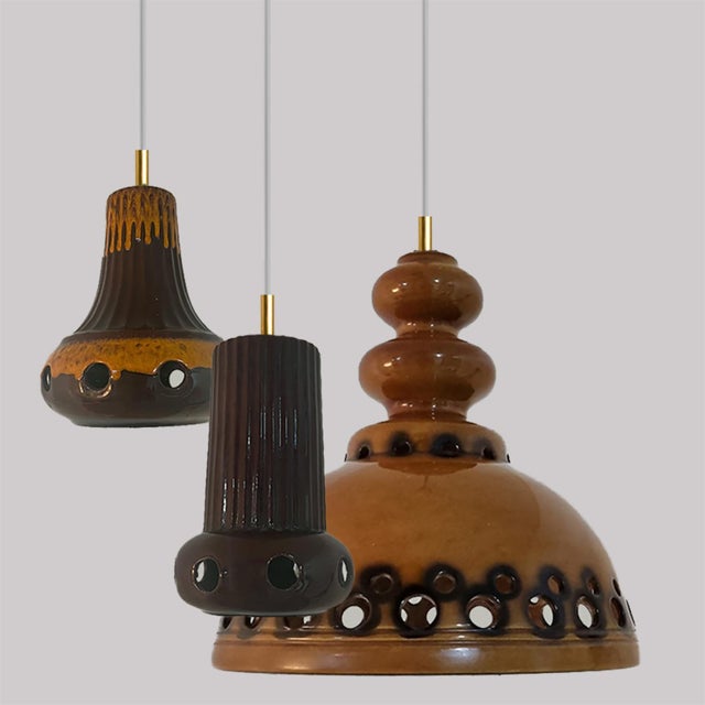 A set of spectacular and stylish ceramic pendant lights made in west-germany around 1970's. The lights are made of orange...