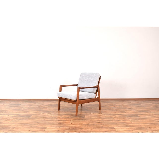 This armchair was designed in the 1960s by Illum Wikkelsø. The lounge chair frame is made of cherry wood and has has been...