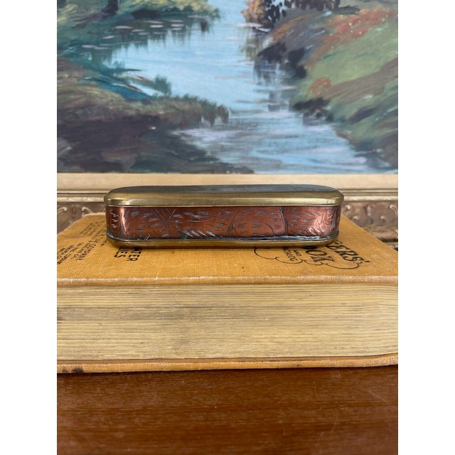 An exceptional 18th century likely Dutch snuff or tobacco box crafted from brass and copper toned materials, richly...
