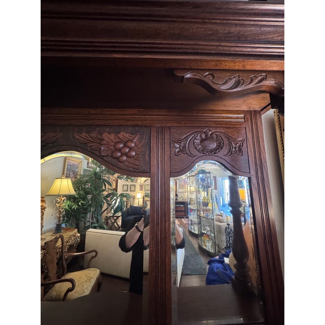 An impressive late 19th-century American Renaissance Revival sideboard featuring an elaborately carved mirrored hutch and...