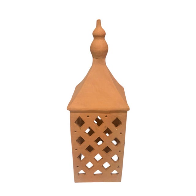 This pair of handmade terracotta lanterns offers a beautiful blend of traditional North African craftsmanship and timeless...