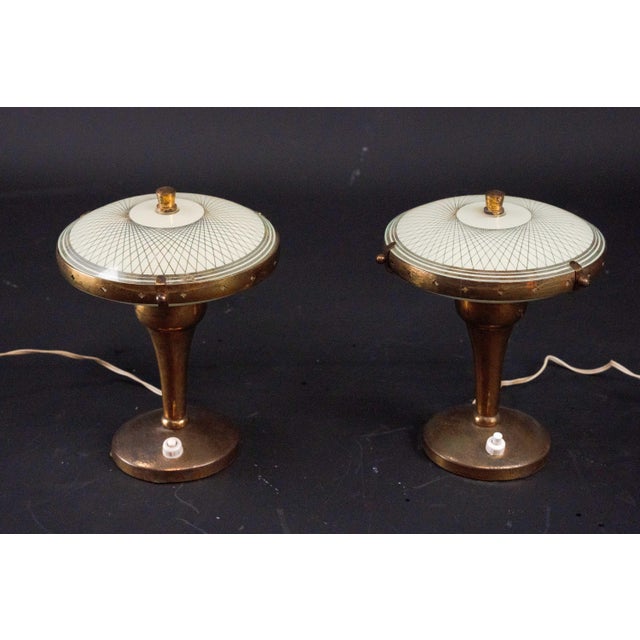 Rare pair of Italian bedside lamps from the 1950s, attributed to Pietro Chiesa. Each lamp features an elegant flared brass...