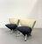 A striking pair of JADA lounge chairs showcasing a sculptural silhouette with gently flared barrel backs, polished chrome...