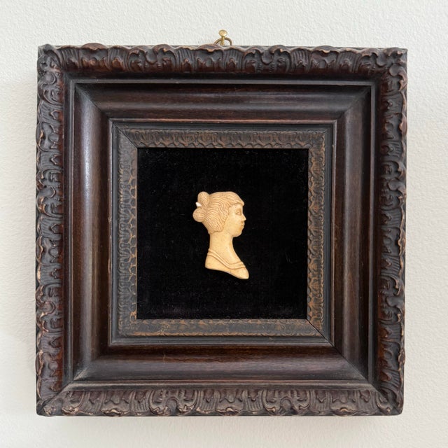 A perfect petite vintage piece to add to a gallery wall, this carved silhouette of a woman in resin is mounted on black...