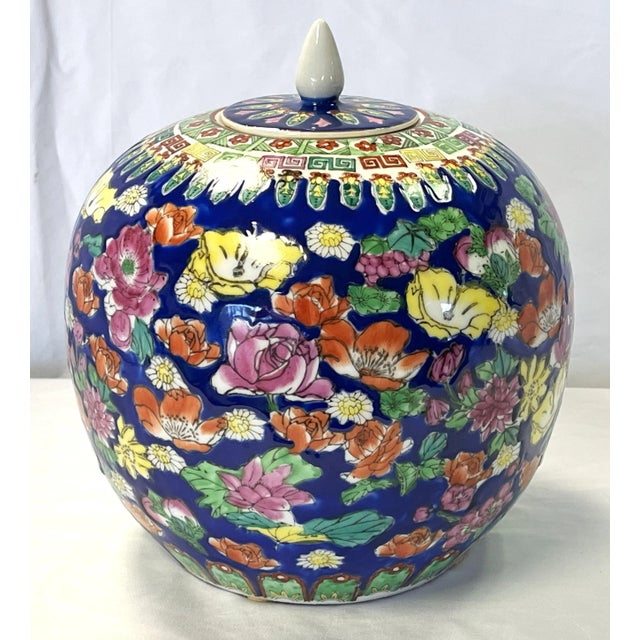 Striking 20th Century Chinese Famille ginger jar. The unique piece is made of porcelain with a blue background, and...