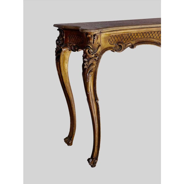 Vintage Italian Louis XV Style Giltwood Console, serpentine-form top over cabriole legs with distressed gilt wood finish....