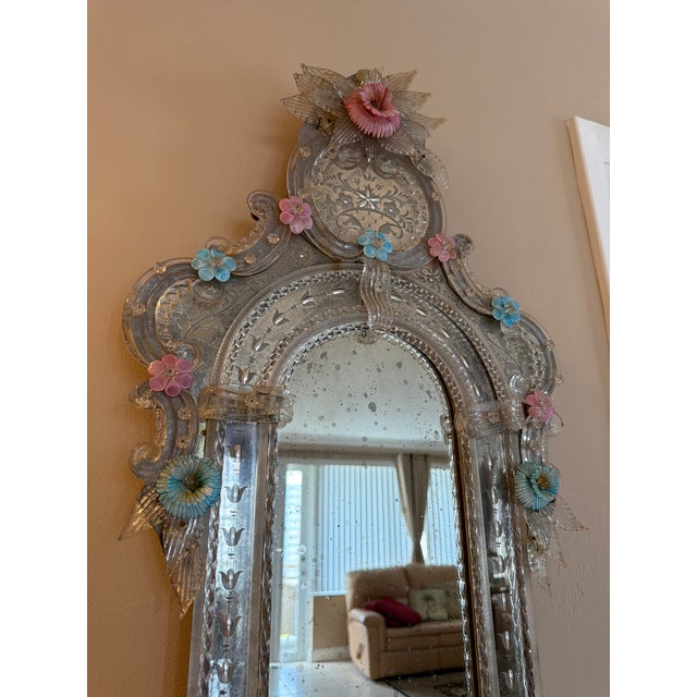 Elongated Murano Glass Mirror. Wooden backings, very heavy. It’s a beautiful piece of history with ornate flowers in pink...