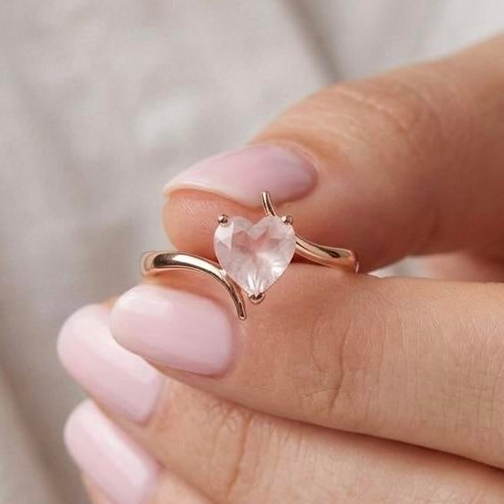 This charming ring features a delicate Rose Quartz gemstone, cherished for its soft, blush-pink tones and romantic allure....