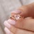 This charming ring features a delicate Rose Quartz gemstone, cherished for its soft, blush-pink tones and romantic allure....