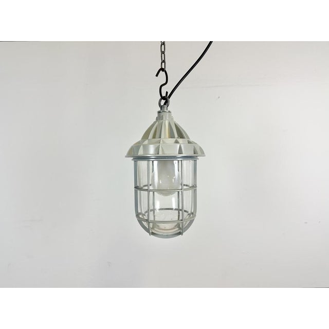 Induatrial cage pendant light made by Yamada Co.Ltd. in Japan during the 1960s. It features a cast aluminium body and a...