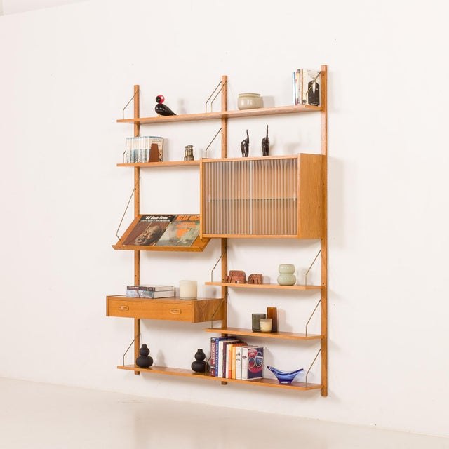 Danish mid-century oak wall unit designed by preben sørensen and manufactured by ps system in randers in the 1970s. It was...