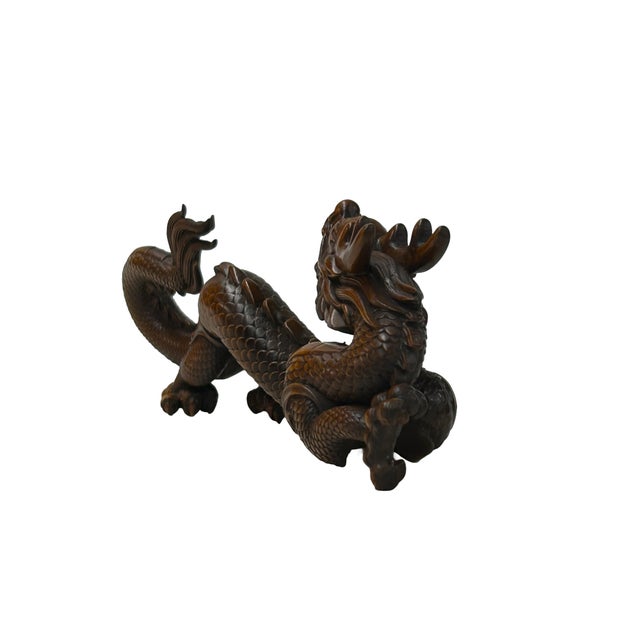Elevate your space with this exquisitely hand-carved wooden dragon figurine, a masterful blend of traditional artistry and...