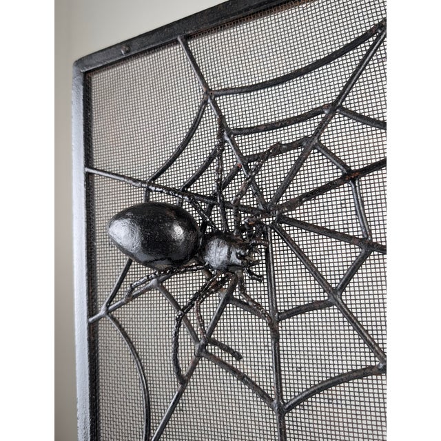 This spark guard represents the handcrafted style of the 1970s, made of wrought iron with a black finish and a metal mesh...