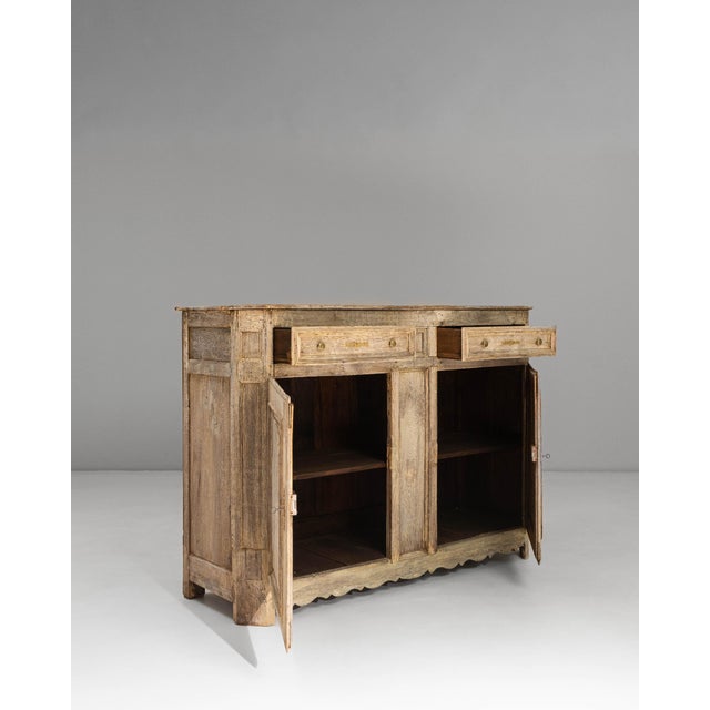 This 1850s French Provincial oak buffet showcases the warm, timeworn character that defines countryside craftsmanship of...