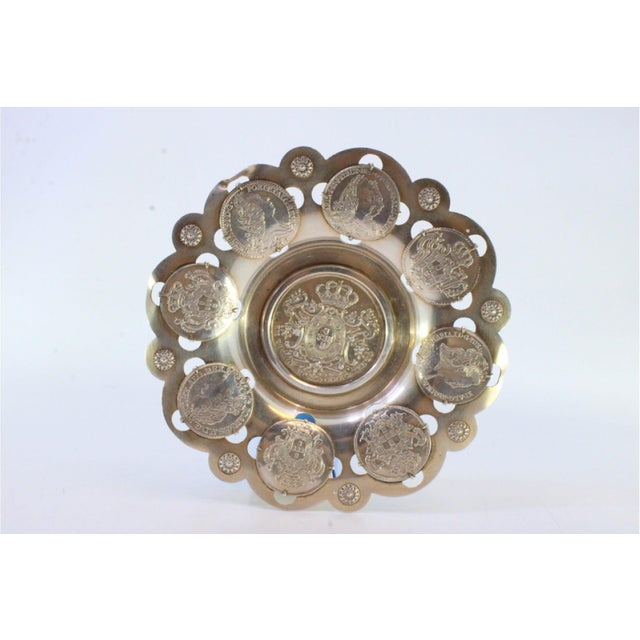 Silver Ring with Rosettes in Relief and Coins, in Very Good conditions. Designed 1890 to 1919 This piece has an...