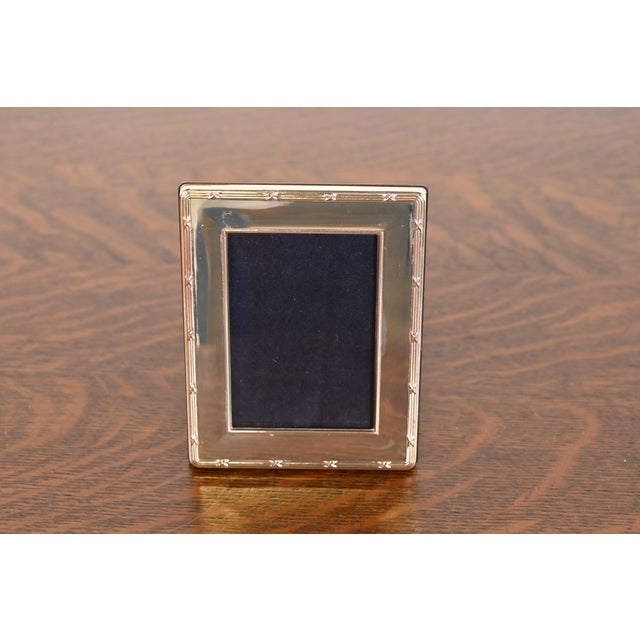 A lovely vintage Art Deco style sterling silver picture frame with blue velvet liner and mahogany backing In the manner of...