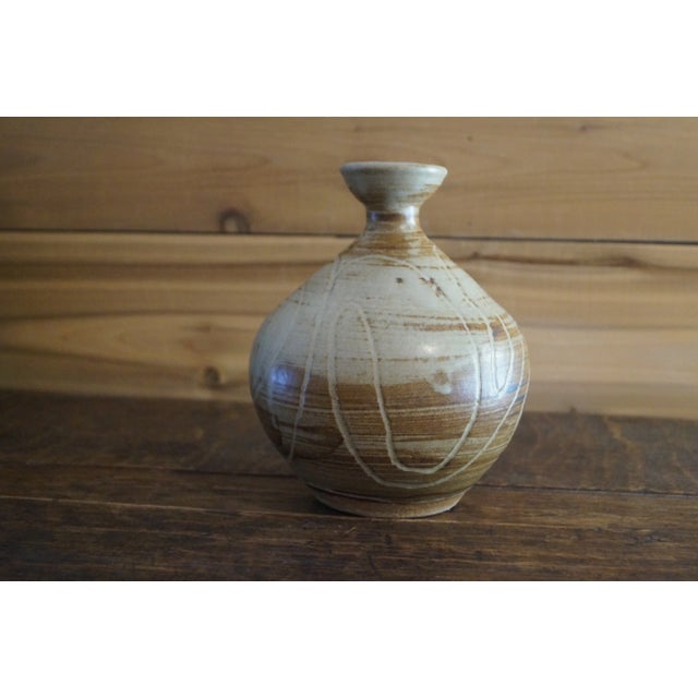 A stunning little 1970s studio pottery vase with an outstanding muted color and carved pattern which is signed is signed...