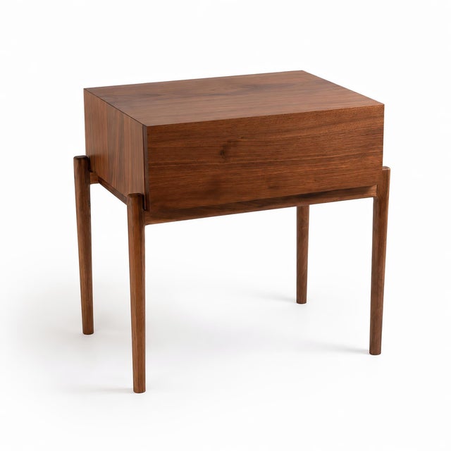 Handmade narrow nightstand with drawer by Live One's, Wake Forest, North Carolina. The cabinet is solid black walnut, with...
