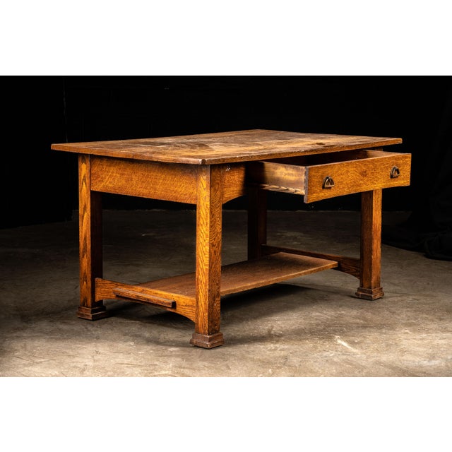 Early 20th-century Arts and Crafts library table constructed of quarter-sawn oak with a rectangular plank top, substantial...