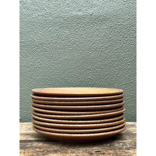 Enhance your tabletop with this warm and tactile set of ten vintage Mid-Century Modern salad plates. Crafted in the USA,...