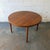 A vintage Danish teak dining table by Vejle Stole, with a round top, gently rounded edge, and four tapered legs. The teak...