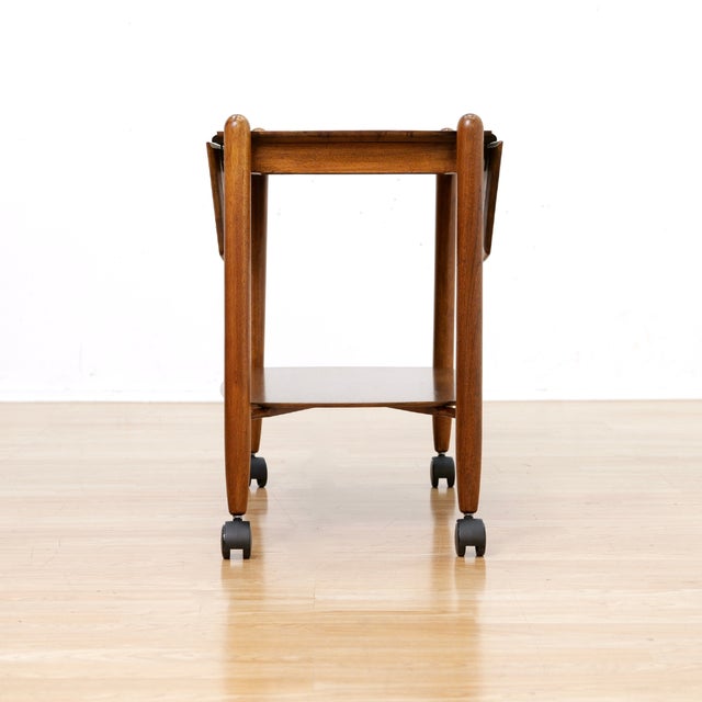 A stunning example of craftsmanship by Peter Hayward for Vanson Furniture, produced during the 1950s. The bar cart is...