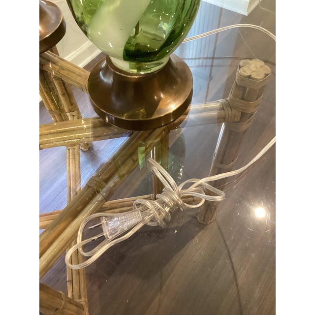 A stunning pair of vintage Murano-style art glass table lamps featuring luminous emerald-green glass with dramatic,...