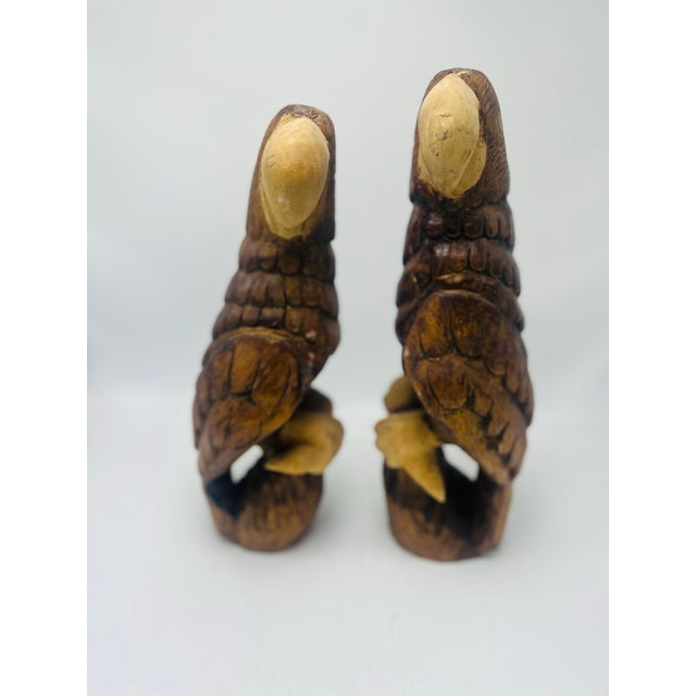 A charming vintage pair of hand-carved wooden parrots. Each bird is carved from solid wood and finished in warm, rich...