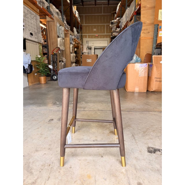 Contemporary counter stool featuring a sculptural open-back silhouette that blends modern elegance with everyday comfort....