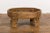 A Tribal Indian rustic teak wood Chakki grinder table from the 1920s with hand-carved geometric motifs, open center,...