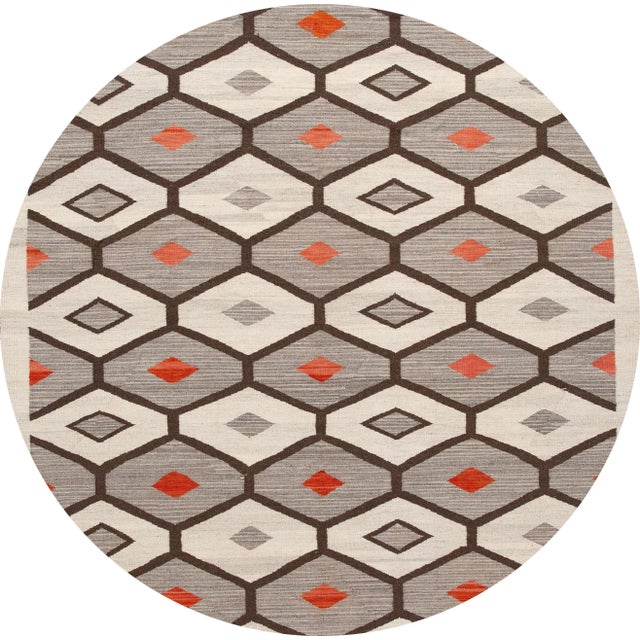 Beautiful contemporary flat-weave Navajo style, a handwoven wool rug with a gray field, ivory, and red accents in an all-...