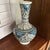 This is an Iznik-style ceramic vase, featuring traditional Ottoman motifs. Iznik pottery originates from the town of İznik...