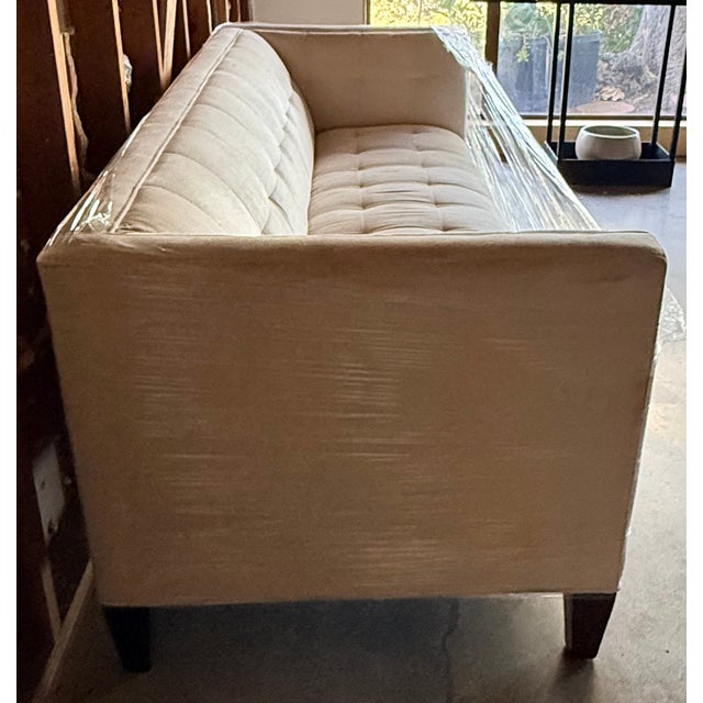 This is classic tuxedo-style sofa features high, straight arms that sit flush with the height of the backrest. The...