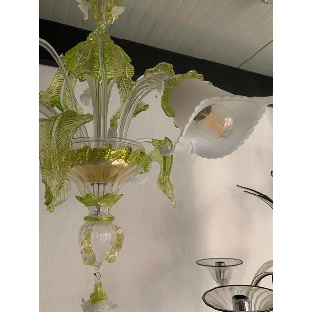 Classical Murano glass chandelier in transparent "rigadin" arms and floral decoration of green leaved and milky "calle"....