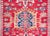 A striking early 20th century Persian Karaja rug with a tribal pattern containing three large central medallions heavily...