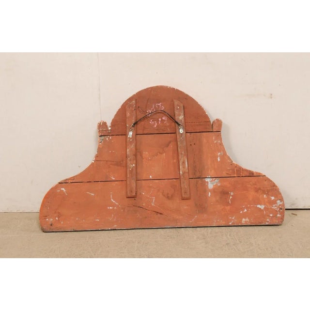 A Spanish carved-wood wall hanging pediment with its original painted finish from the 19th century. This antique wooden...