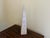 A beautifully proportioned marble obelisk in richly veined shades of brown, cream, and grey. The sculptural silhouette and...