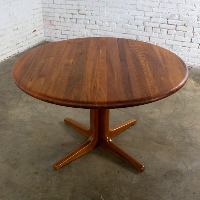 Handsome Mid-20th Century Scandinavian Modern solid teak round to oval expanding dining table with 2 leaves by Glostrup...
